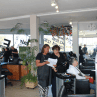Two Hair Frame hairdressers reviewing a hair appointment while a client waits for her haircut at a Somerset West hair salon.