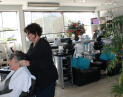 Hair Frame stylist sectioning older woman’s hair, preparing for professional haircut and styling at Hair Frame salon