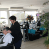 Hair Frame stylist sectioning older woman’s hair, preparing for professional haircut and styling at Hair Frame salon