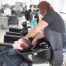 A woman getting her hair rinsed after hair dye treatment at Hair Frame salon.