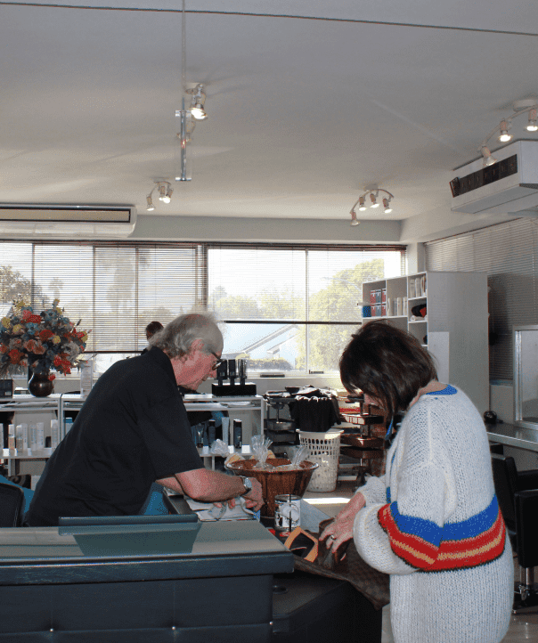 Satisfied client paying at Hair Frame, an affordable Somerset West hair salon.