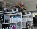 Hair Frame stylist sectioning older woman’s hair, preparing for professional haircut and styling at Hair Frame salon